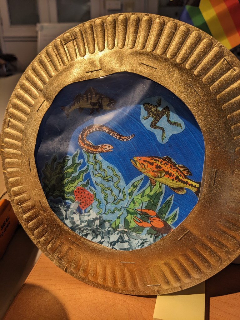 Student artwork depicting Lake Ontario aquatic life inside a circular "porthole" frame.