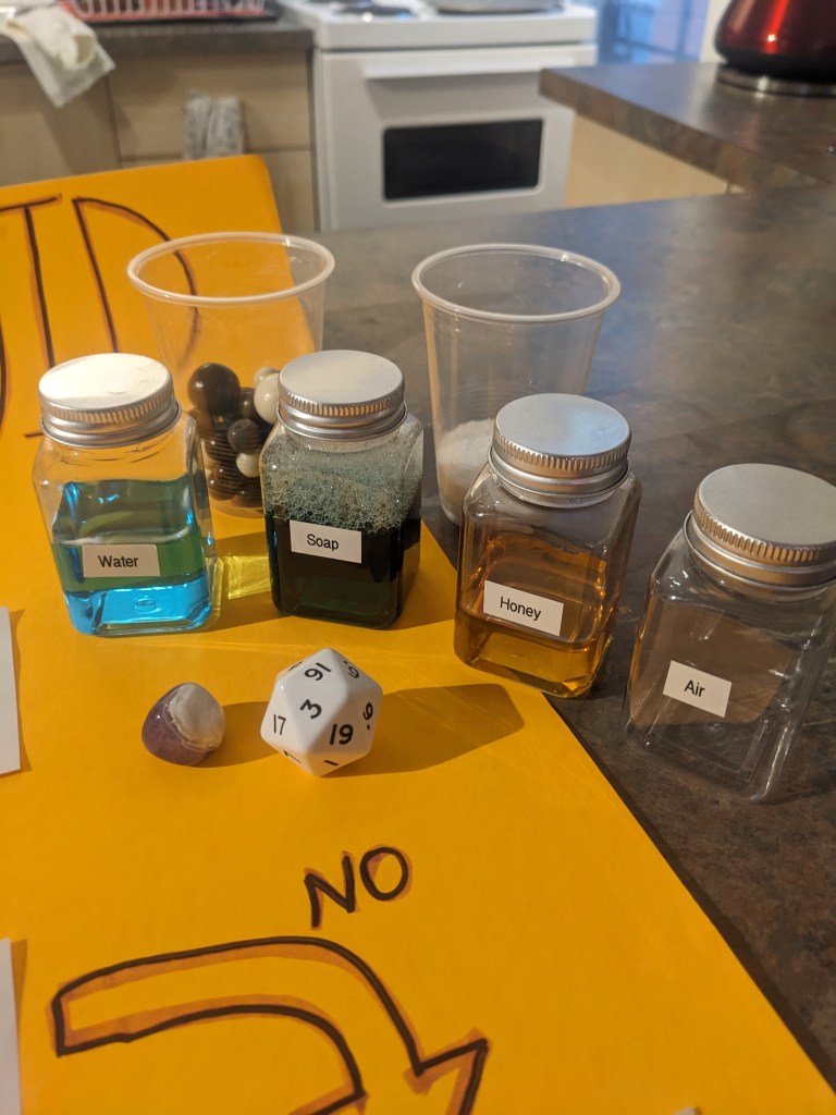 Close up on the items used with the solid, liquid, gas flow chart.