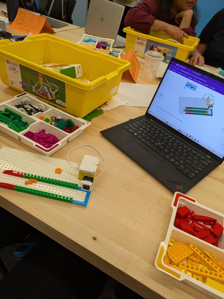 Lego robotics blocks, and an open laptop with the coding blocks open.